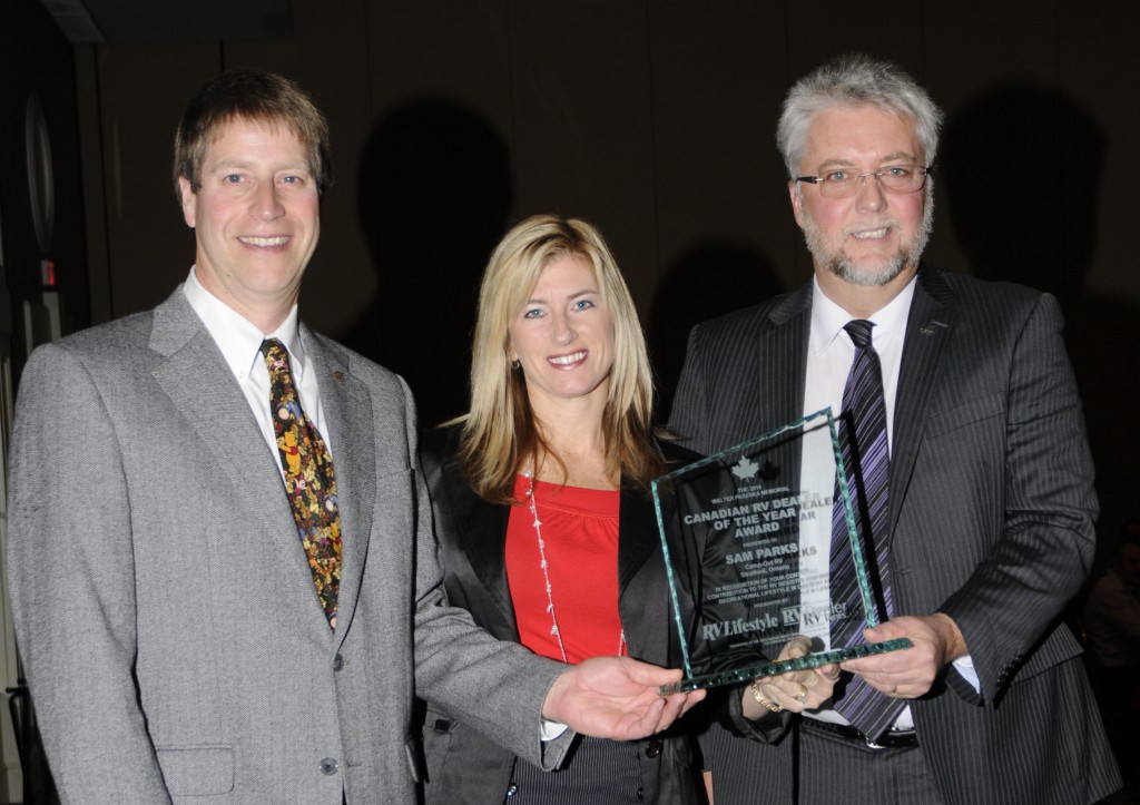 L-R: Ian Moore, the 2013 Canadian RV Dealer of the Year, and Melanie Taylor, Associate Publisher of RV Lifestyle Magazine, present the 2015 Canadian RV Dealer of the Year Award to Sam Parks, Camp-Out RV, Stratford Ontario, at the RVDA of Canada Award Diner in Louisville, KY, Monday November 30, 2015. 