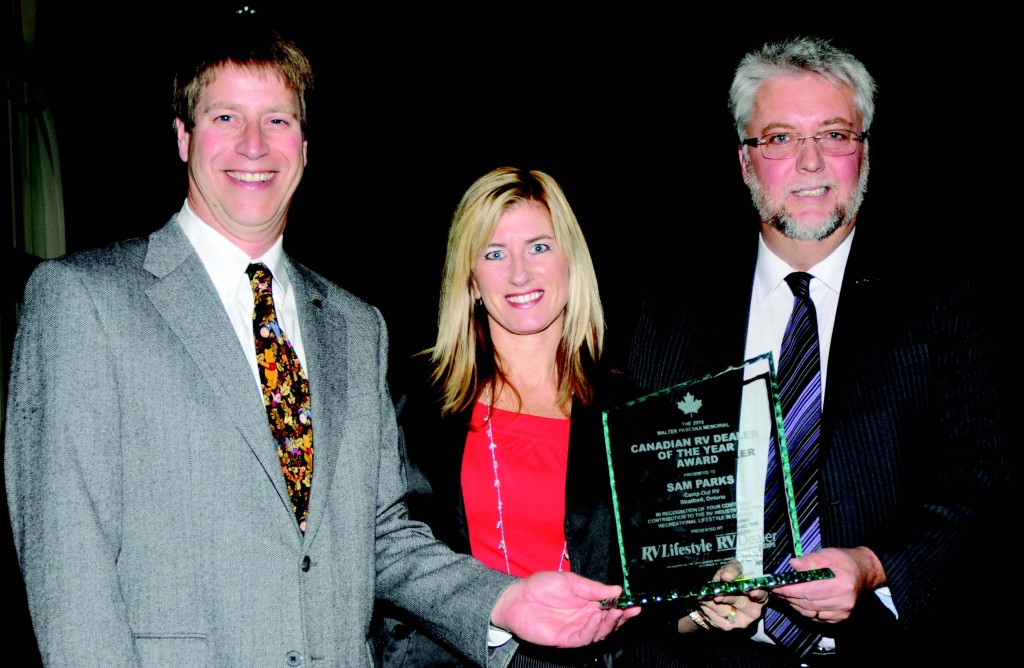2013 Canadian RV Dealer of the Year Ian Moore and RV Dealer News associate publisher Melanie Taylor congratulate Sam Parks on being named 2015 Canadian RV Dealer of the Year.
