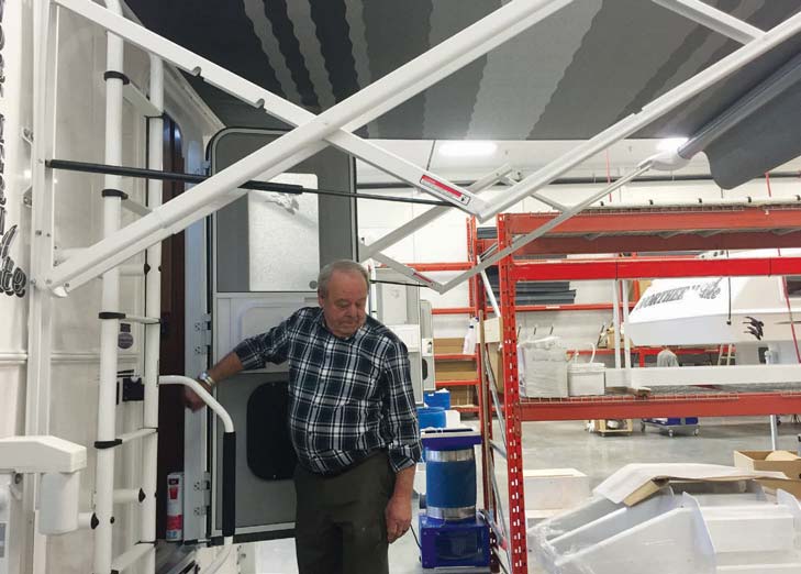 The new production line includes the latest innovations in RV manufacturing. Mac Donkin demonstrating the 7-foot automatic awning.