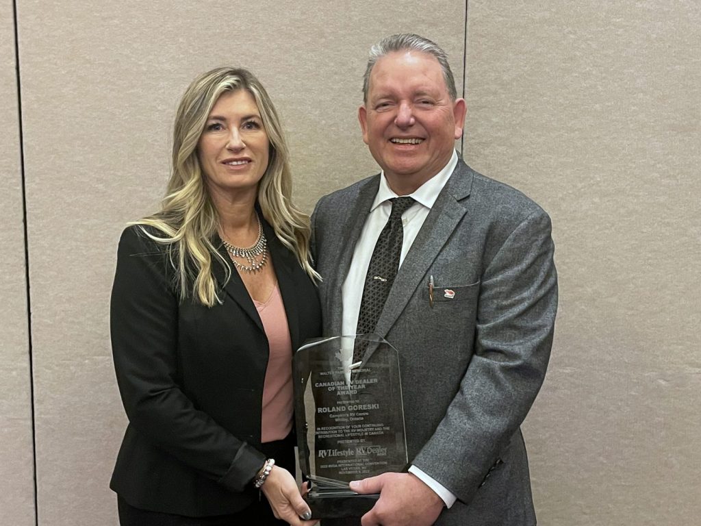 Melanie Taylor, left, from RV Lifestyle Magazine and RV Dealer News, presented the 2022 Canadian RV Dealer of the Year Award to Roland Goreski, of Campkin's RV Centre, Whitby, Ontario.