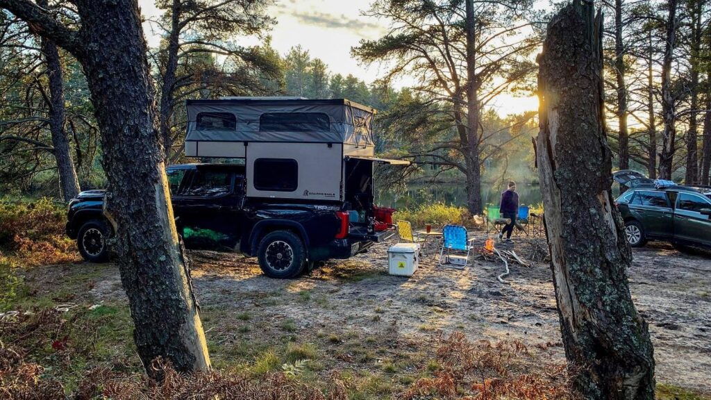 Soaring Eagle OV-X5.0 truck camper, in a camping environment.