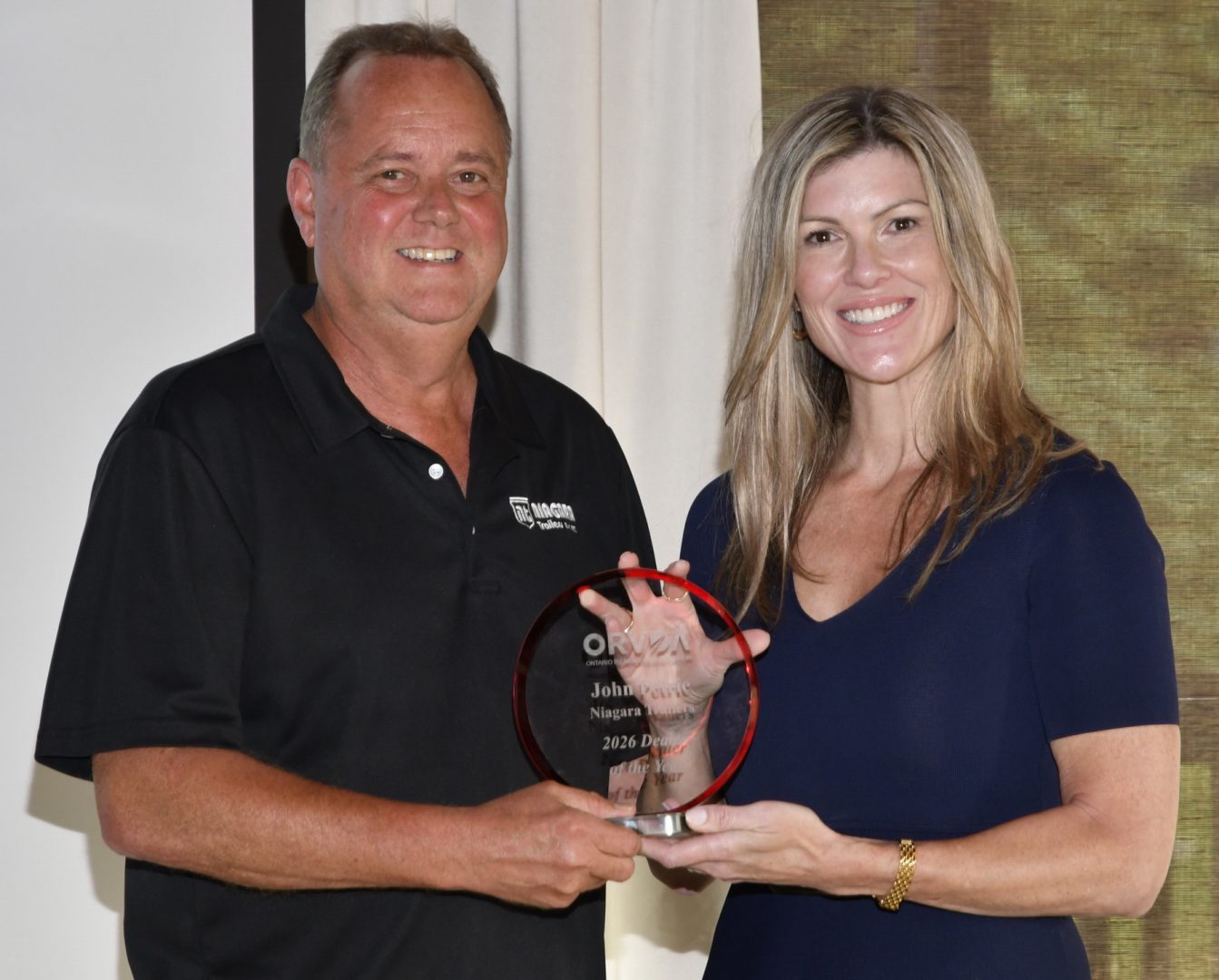 John Petrie, of Niagara Trailers, St. Davids Ontario, receives the 2026 ORVDA RV Dealer of the Year Award from Natalie Conway.