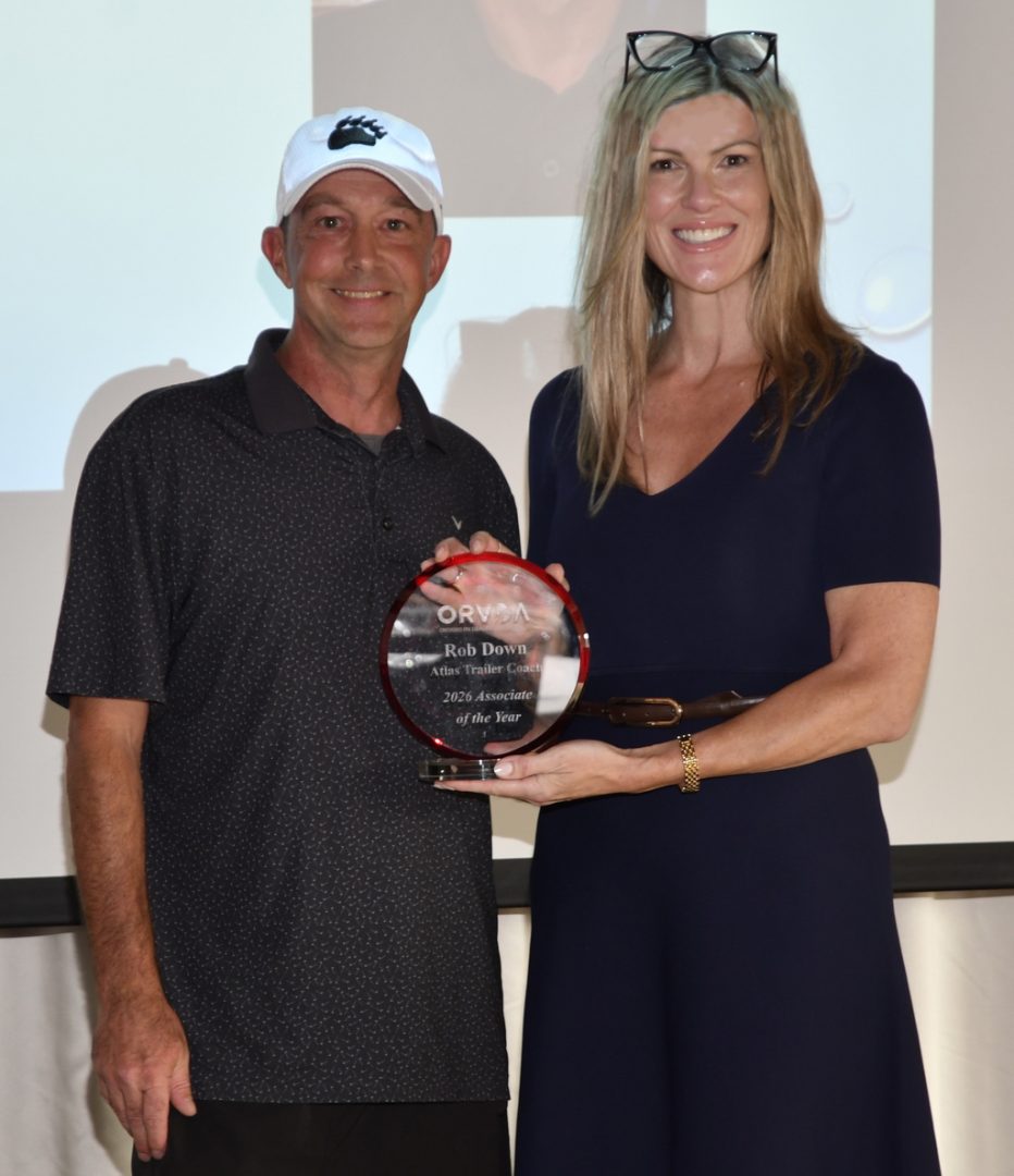 Rob Down of Atlas Trailer Coach Products, London, Ontario receives the ORVDA Associate of the Year Award from Natalie Conway.