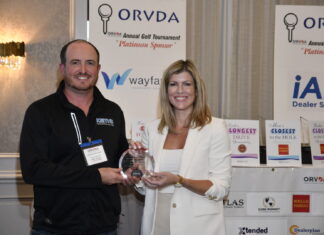 Keith Barrick, of Keith's Trailer Sales, Orton, Ontario, receives the ORVDA Dealer of the Year Award from Natalie Conway.