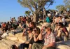 A crowd uses handheld solar viewers and solar eclipse glasses to safely view a solar eclipse. Credit: National Park Service