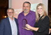 John Krohnert, left, and Natalie Conway, right, present the ORVDA RV Dealer of the Year Award to Richard Tache.