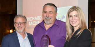 John Krohnert, left, and Natalie Conway, right, present the ORVDA RV Dealer of the Year Award to Richard Tache.