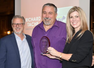 John Krohnert, left, and Natalie Conway, right, present the ORVDA RV Dealer of the Year Award to Richard Tache.