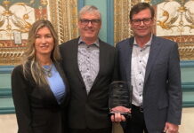 Melanie Taylor, left, Associate Publisher of RV Lifestyle Magazine and RV Dealer News, presented the 2024 Canadian RV Dealer of the Year Award to Kyle Redmond, centre, and Jeff Redmond, right, of Bucars RV, Balzac, AB.