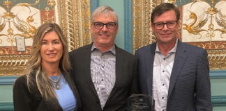 Melanie Taylor, left, Associate Publisher of RV Lifestyle Magazine and RV Dealer News, presented the 2024 Canadian RV Dealer of the Year Award to Kyle Redmond, centre, and Jeff Redmond, right, of Bucars RV, Balzac, AB.